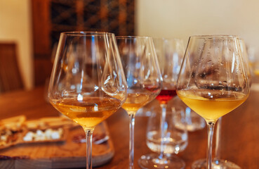 Glass goblets placed in rows on table during wine tasting procedure in restaurant