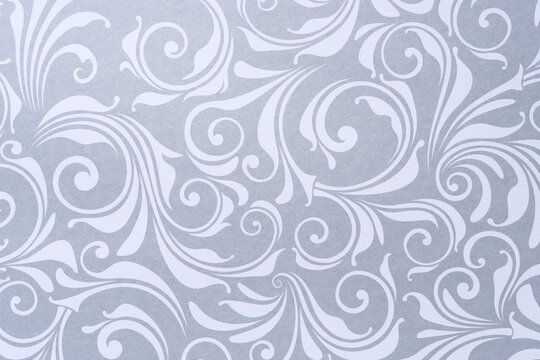 decorative scrapbooking sheet with floral patterns or swirls in silver gray