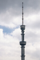 Fototapeta premium Koktobe Television and radio broadcast tower in Almaty, Kazakhstan. TV towers against the background of a cloudy sky.