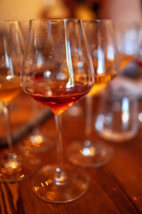 Glass goblets placed in rows on table during wine tasting procedure in restaurant