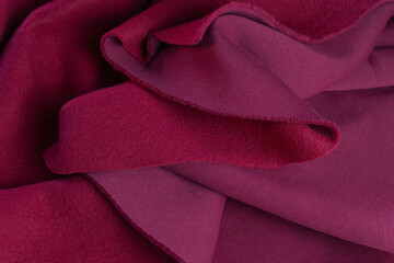 Piece of fabric lies in beautiful waves. layers of French terry pink amaranth textile. cut for...