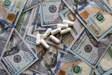 Pills on the background of the dollar close-up.