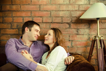 Happy couple sitting on sofa