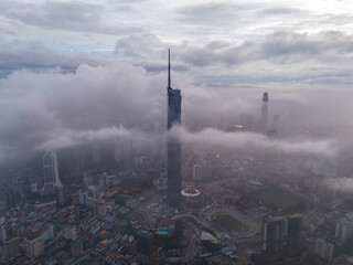 Aerial view of Kuala Lumpur city skyline under a low cloud sky