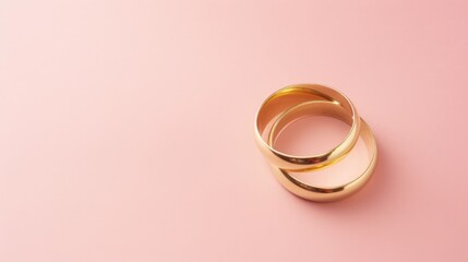 Pink pastel background with copy space and wedding golden rings - obrazy, fototapety, plakaty