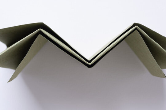folded paper standing on edge