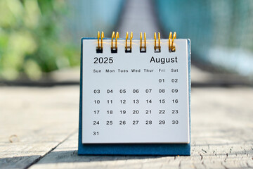 August 2025 white calendar with green blurred background. New year concept.
