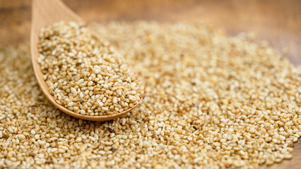 Close-up shot of garlic sesame seeds with wooden spoon, Selective focus