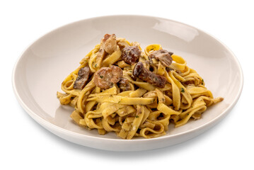 Egg noodles pasta with mushroom sauce, mushroom tagliatelle in white dish isolated on white with clipping path included