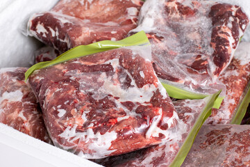 Frozen food. Frozen pork meat which has been vacuum sealed inside a fridge freezer.