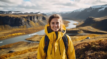 Young woman tourist in a yellow coat Iceland landscapes in the background - obrazy, fototapety, plakaty