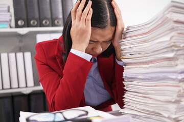 Asian and African office workers trying to feel bored, unhappy and bored working in the office. Business woman. Office worker working with pile of A4 papers. Happy working. Working.