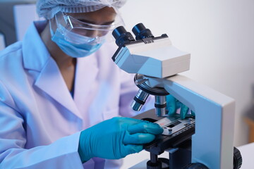 Naklejka na ściany i meble Science test tubes, laboratory equipment for new medical research, microbiology research with small pipettes in close-up. Asian and African female scientists in the laboratory, perfume samples