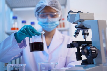 Science test tubes, laboratory equipment for new medical research, microbiology research with small pipettes in close-up. Asian and African female scientists in the laboratory, perfume samples