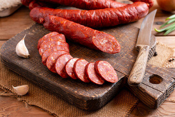Smoked sausage on a wooden rustic board. Rustic table