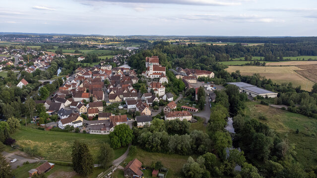 Scheer on the Danube river with St. Nicholas Church, taken from the air, drone image