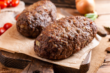 Tasty homemade ground baked meatloaf on wooden table. Food. Traditional czech meat loaf.