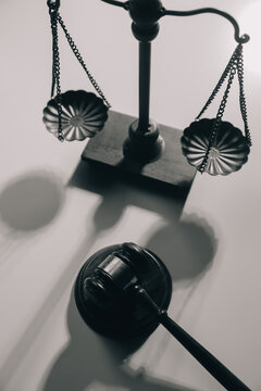 image of judge's hammer, scales lady of justice, law book, laptop computer and contract documents with pen concept of law and justice.