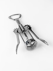 Glossy metal wine bottle opener isolated over the white background