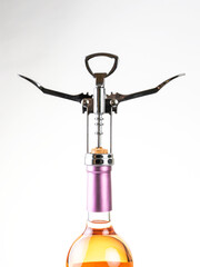 Opening a wine bottle on white background