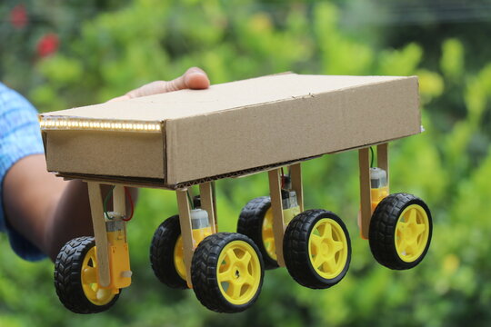 Robotic car that can be controlled by a smartphone and having a six wheel drive system held in the hand