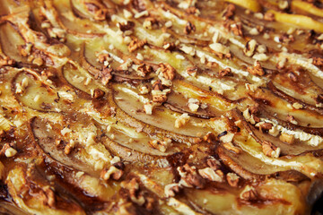 Close up of freshly baked homemade pie. Puff pastry pie with camembert, pear slices, honey and walnuts