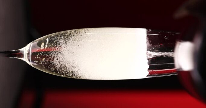Glass of champagne on a black isolated background. Capturing the effervescence: Slow-motion, super macro shot showcasing delicate champagne bubbles gracefully rising in an elegant glass against a pris