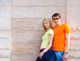 Couple standing near the wall outdoors