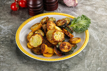 Roasted young zucchini in the plate