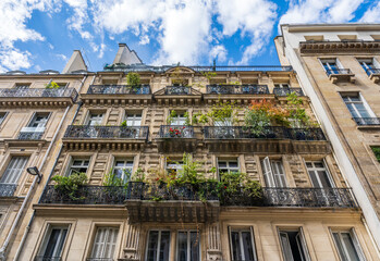 Glimpse of a typical and elegant residential building in Rue Moliere, Paris city center, France, with wrought iron railings and balconies 