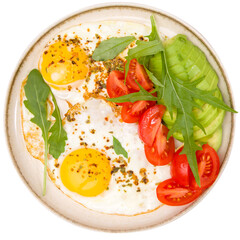 Fried eggs with vegetables on a plate. Isolated over white background