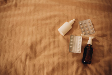 medicine and cold pills lie on the bed