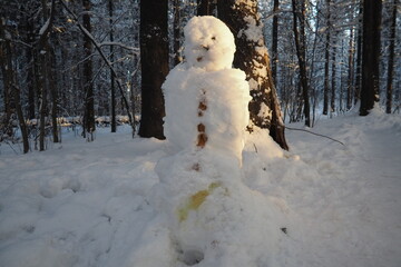 Snowman, snow woman, stylized snow figure of a person, sculpture. Making a snowman is a winter...