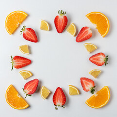 Colorful pattern made of citrus fruits and strawberries. Minimal summer concept.