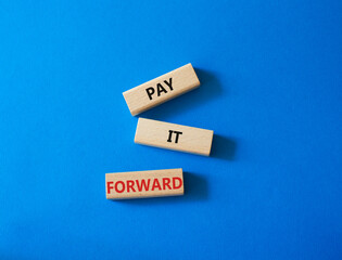 Pay it forward symbol. Concept words Pay it forward on wooden blocks. Beautiful blue background. Business and Pay it forward concept. Copy space.