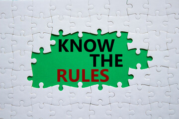 Know the rules symbol. Concept words Know the rules on white puzzle. Beautiful green background....