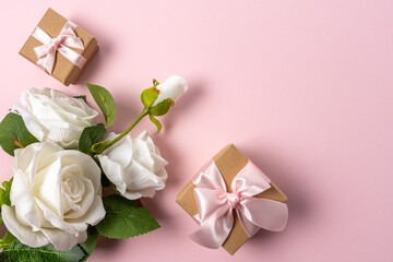 Creative layout made with flowers on pink backdrop. Spring minimal concept.