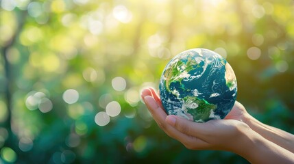Sustain earth concept: Human hands holding global over blurred blue nature background