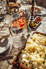 hairs and a table for guests, decorated with candles, are served with cutlery and crockery