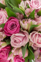 A bouquet of roses, alstroemeria, hellebore in pink shades of color. Close-up. Floral background.