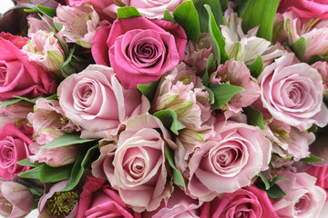 A bouquet of roses, alstroemeria, hellebore in pink shades of color. Close-up. Floral background.