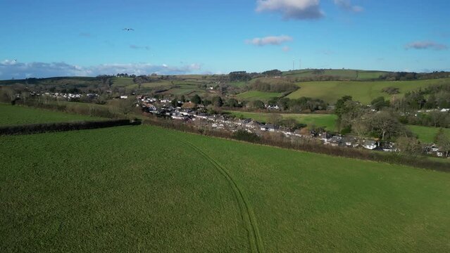Yalberton, South Devon, England: DRONE VIEWS: The drone reverses over country fields before flying over Yalberton industrial estate showing factories and warehouses as an example of urban creep.