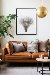 A mid-century modern living room with a brown leather couch and a tree artwork