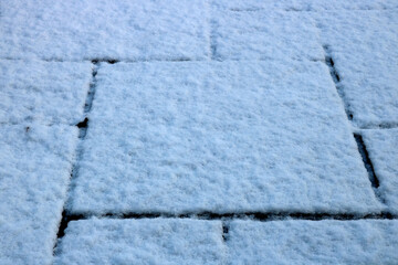 Snow Covered Patio Slabs on a Winter Morning - 703979971