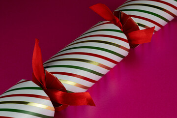 Striped Christmas Cracker on a Pink Surface - 703979979