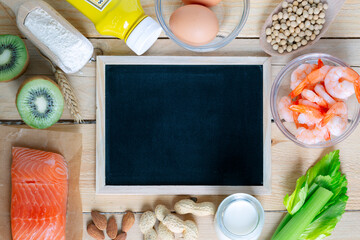 Composition with common food allergens including egg, milk, soya, peanuts, kiwi, fish, seafood, wheat flour, mustard, celery with blackboard for copyspace