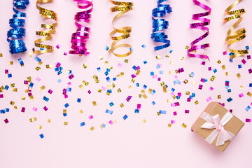 Colorful celebration background with various party confetti and gift box. Minimal party concept. Flat lay.