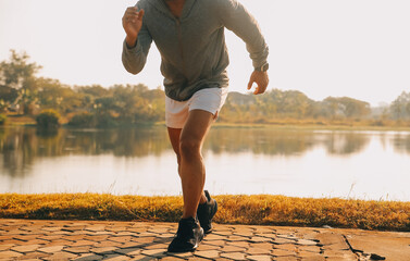 Athlete runner feet running on road, Jogging concept at outdoors. Man running for exercise..Athlete...