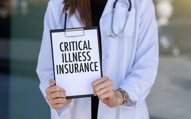 Doctor Holding Card in Hands and Pointing the Word CRITICAL ILLNESS INSURANCE.