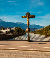 Alpine summer view with a religious cross on a bridge at Innsbruck, Tyrol, Austria